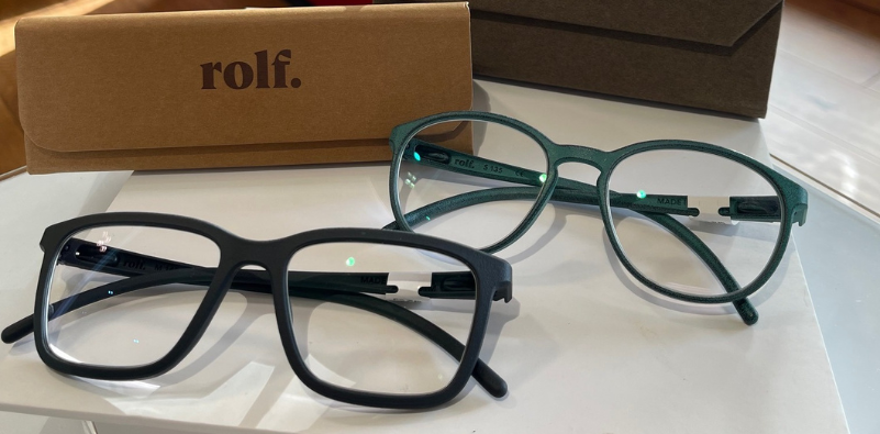 A pair of Rolf Eyewear glasses and case on a table at the opticians