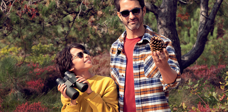 Sourced from HOYA Lens UK. Image of a man and his son outside wearing HOYA Sensity lenses.