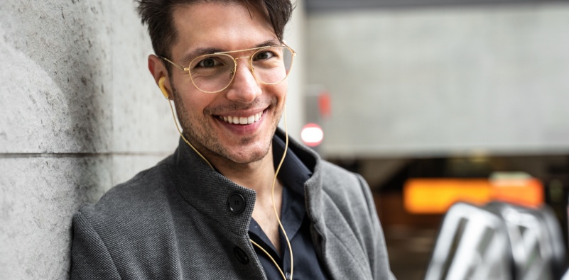 Image of a man wearing aviator glasses listening to headphones.