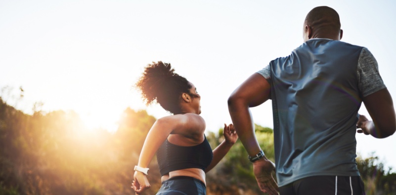 Man and woman out running for exercise during the day