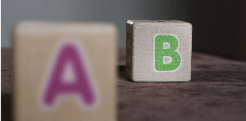 A visual representation of hyperopia with letter blocks. The closest block is blurred while the block in the background is clear