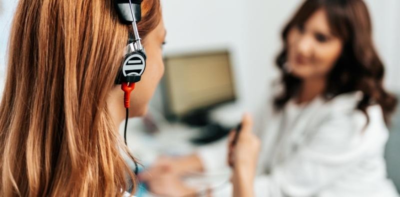  A patient having a hearing test with an audiologist in a clinical setting.